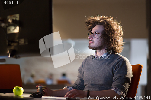 Image of Tired businessman working late