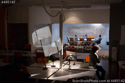 Image of man working on computer in dark office