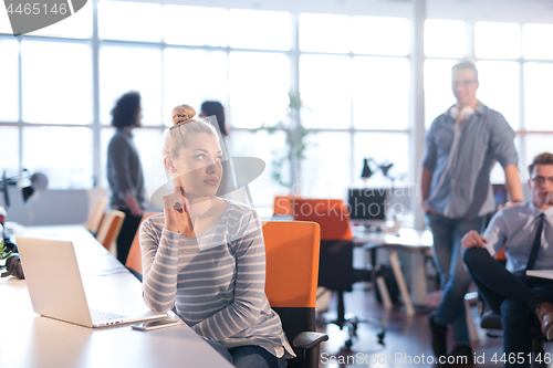 Image of businesswoman using a laptop in startup office