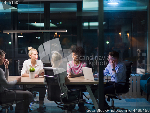 Image of Multiethnic startup business team in night office