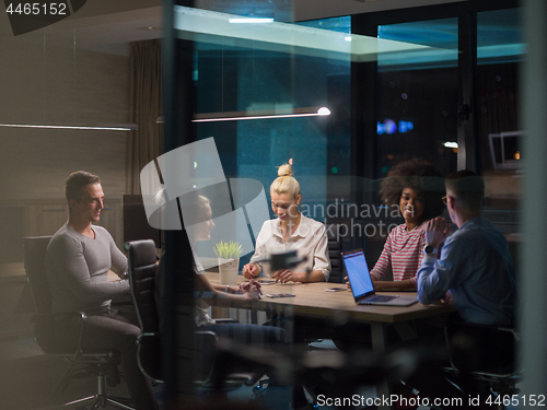 Image of Multiethnic startup business team in night office