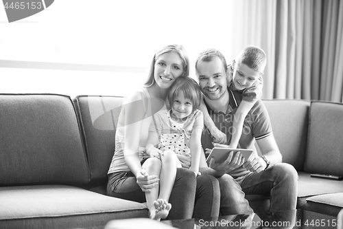 Image of happy young couple spending time with kids