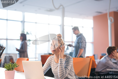 Image of businesswoman using a laptop in startup office