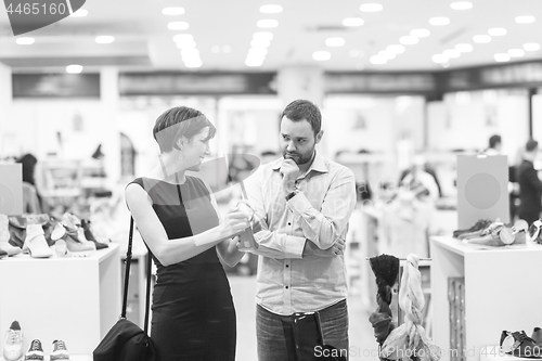 Image of couple chooses shoes At Shoe Store