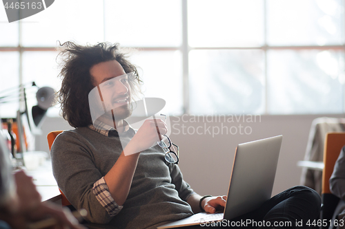 Image of businessman working using a laptop in startup office