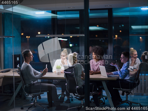 Image of Multiethnic startup business team in night office