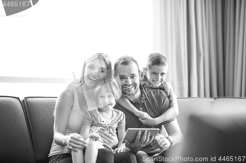 Image of happy young couple spending time with kids