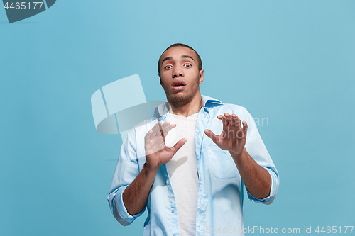 Image of Portrait of the scared man on blue