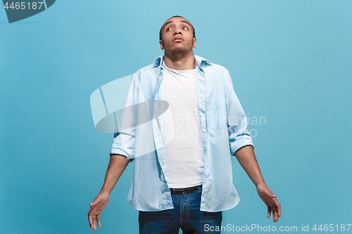 Image of Young serious thoughtful businessman. Doubt concept.