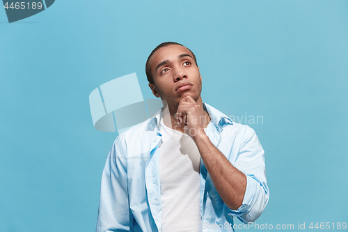 Image of Young serious thoughtful businessman. Doubt concept.