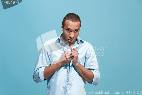 Image of Afro man looking suprised and bewildered isolated on blue