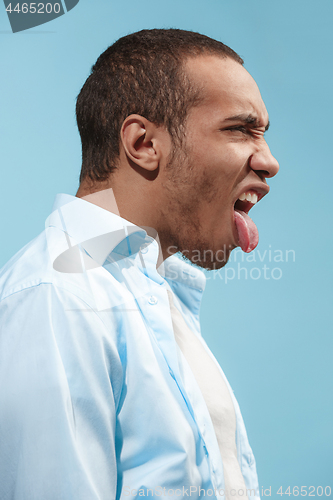 Image of Crazy Afro-American man is looking funny against blue background