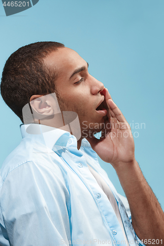 Image of Sad Afro-American man is having toothache. against blue background