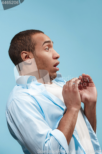 Image of Portrait of the scared man on blue