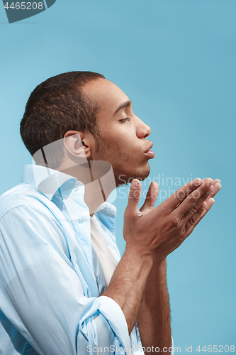 Image of Portrait of attractive man with kiss isolated over blue background