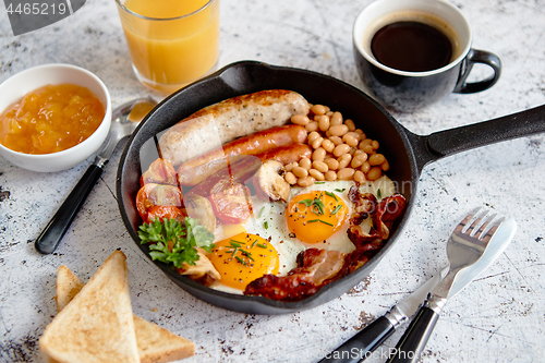 Image of Delicious english breakfast in iron cooking pan