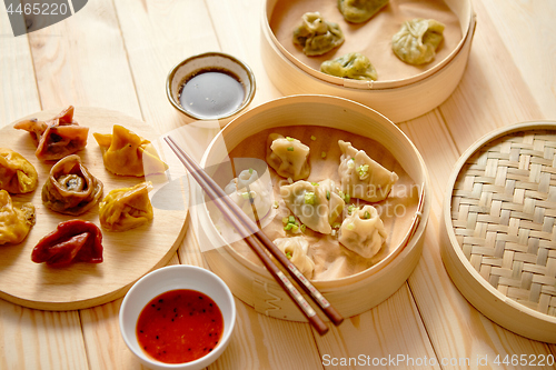 Image of Traditional chinese dumplings served in the wooden bamboo steamer