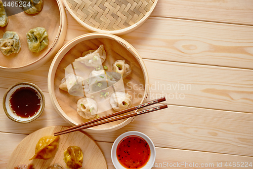 Image of Traditional chinese dumplings served in the wooden bamboo steamer