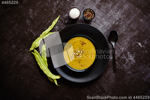 Image of Creamy soup with green pea in a ceramic white plate