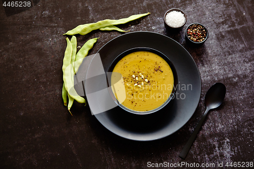 Image of Creamy soup with green pea in a ceramic white plate