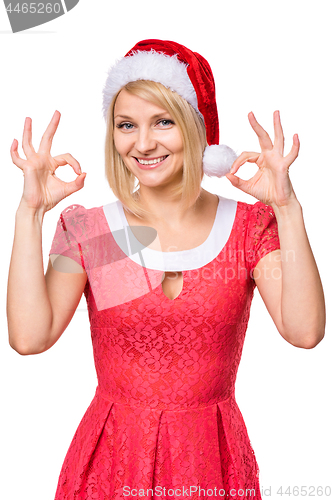 Image of Woman in santa hat making ok