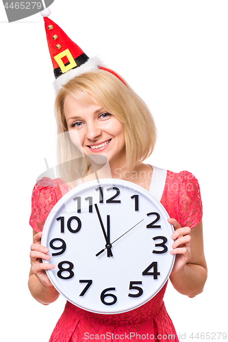 Image of Woman in santa hat with clock