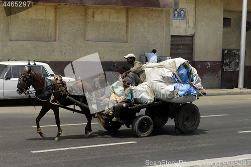 Image of Men transport garbage