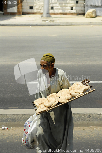 Image of poor old man sells wheat flat cakes