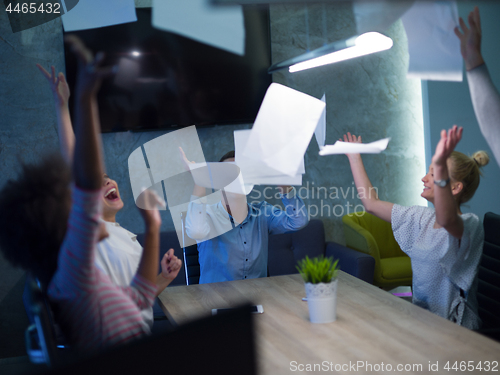 Image of multiethnic Group of young business people throwing documents