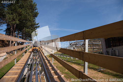 Image of mother and son enjoys driving on alpine coaster