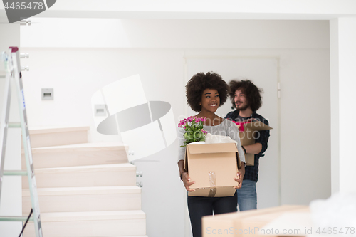 Image of multiethnic couple moving into a new home