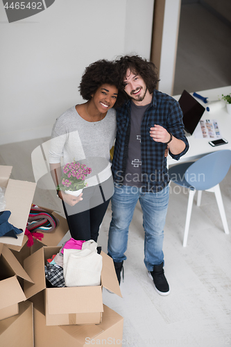 Image of multiethnic couple moving into a new home