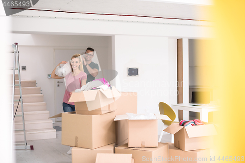 Image of couple carrying a carpet moving in to new home