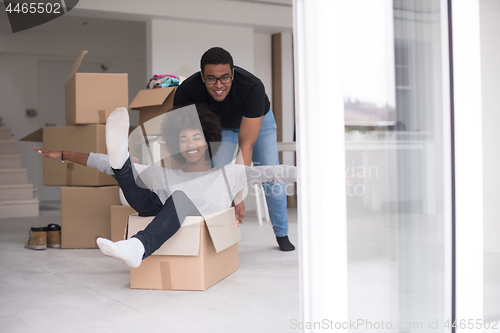 Image of African American couple  playing with packing material