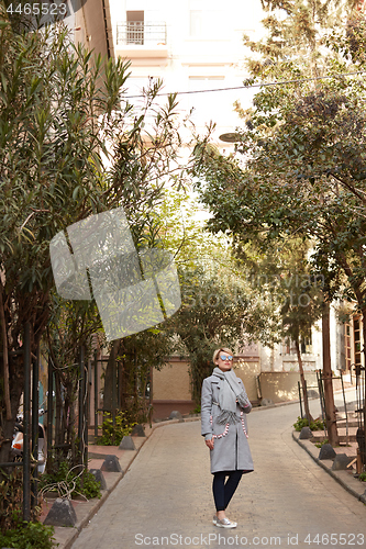 Image of Young blond woman with sunglases on the street