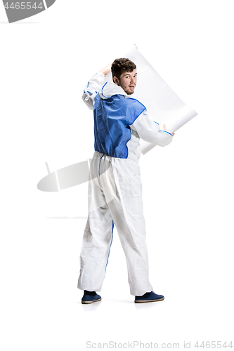 Image of Young male decorator painting with a poster climbed a ladder isolated on white background.