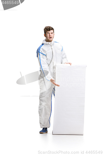 Image of Young male decorator painting with a poster climbed a ladder isolated on white background.