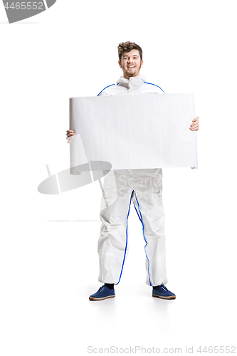 Image of Young male decorator painting with a poster climbed a ladder isolated on white background.