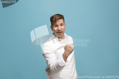 Image of Winning success man happy ecstatic celebrating being a winner. Dynamic energetic image of male model