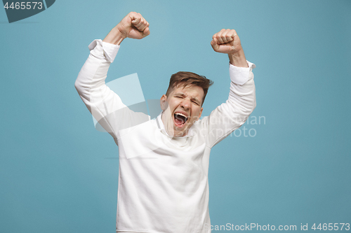 Image of Winning success man happy ecstatic celebrating being a winner. Dynamic energetic image of male model