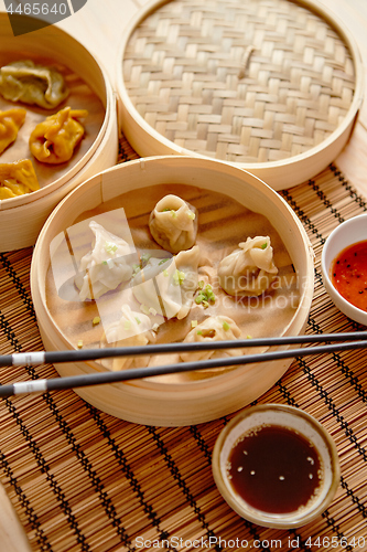 Image of Oriental traditional chinese dumplings served in the wooden steamer