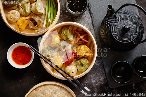 Image of Oriental traditional chinese dumplings served in the wooden steamer