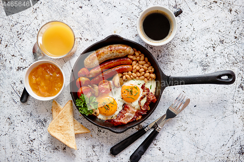 Image of Delicious english breakfast in iron cooking pan