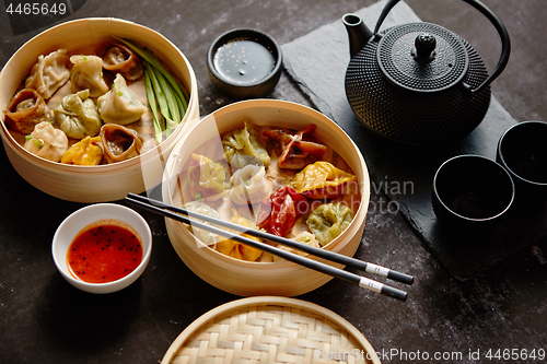 Image of Composition of chinese food. Mixed kinds of dumplings from woode
