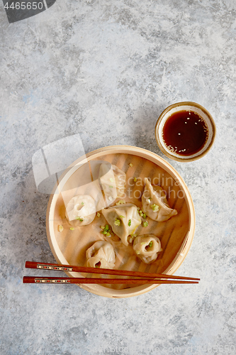 Image of Delicious chinese dumplings served in wooden bamboo steamer