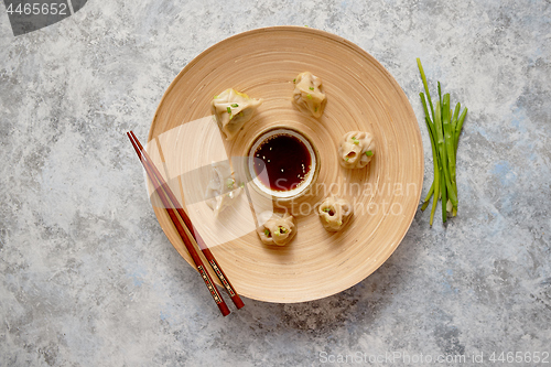 Image of Delicious chinese dumplings served on wooden plate