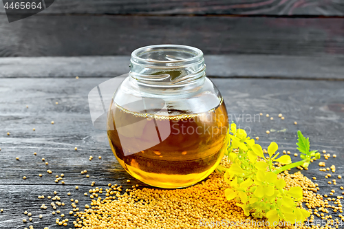 Image of Oil mustard in jar with flower on board