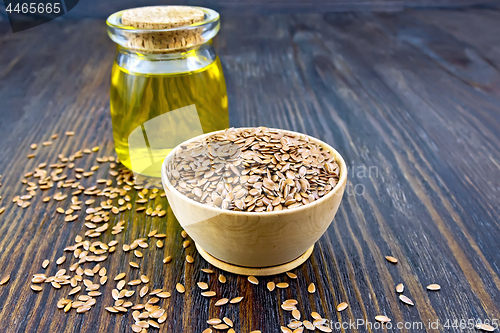 Image of Flaxen brown seed in bowl with oil on board