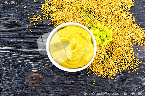 Image of Sauce mustard in bowl with flower on board top