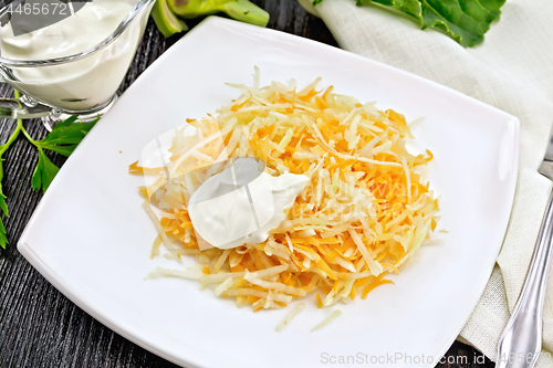 Image of Salad of carrot and kohlrabi with sour cream on black board